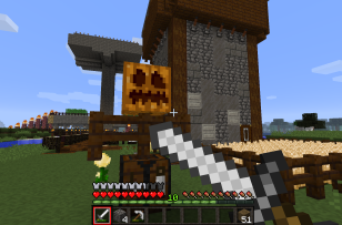 The player's point of view where she is looking at a scarecrow next to some crops. The player is using her sword in defence.